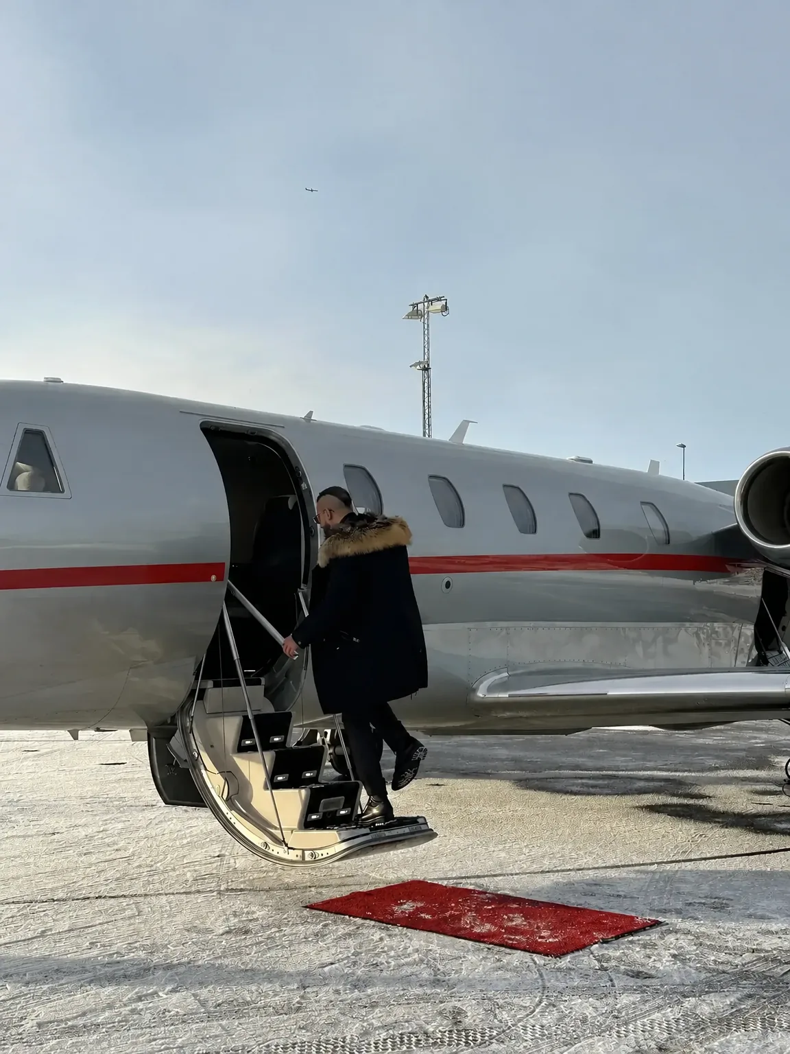 Boarding a private jet on a snowy runway