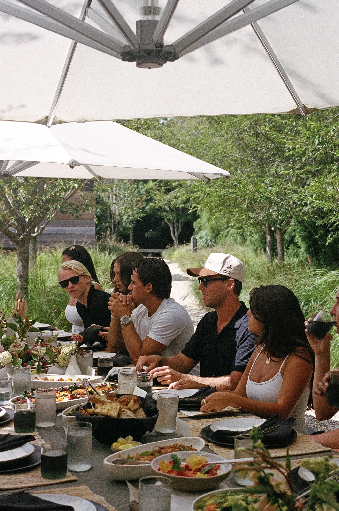 Guests sharing dishes at a long table